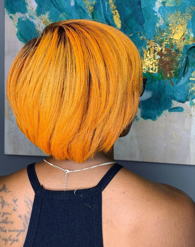 Photo of woman with orange hair, just after precision trim.
